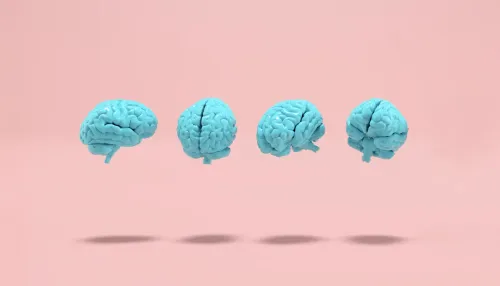 Blau gefärbte menschliche Gehirne, die auf rosa Hintergrund schweben.